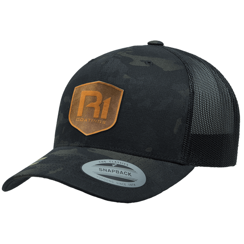 We The Essentials Multicam Black Trucker Hat with Orange Patch